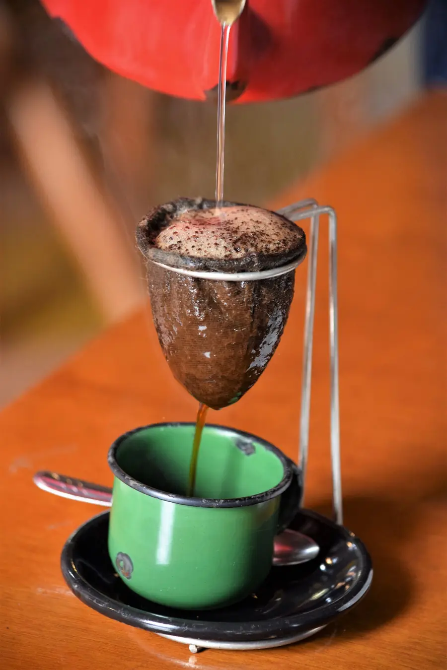 Brazilian coffee being poured through a cloth filter