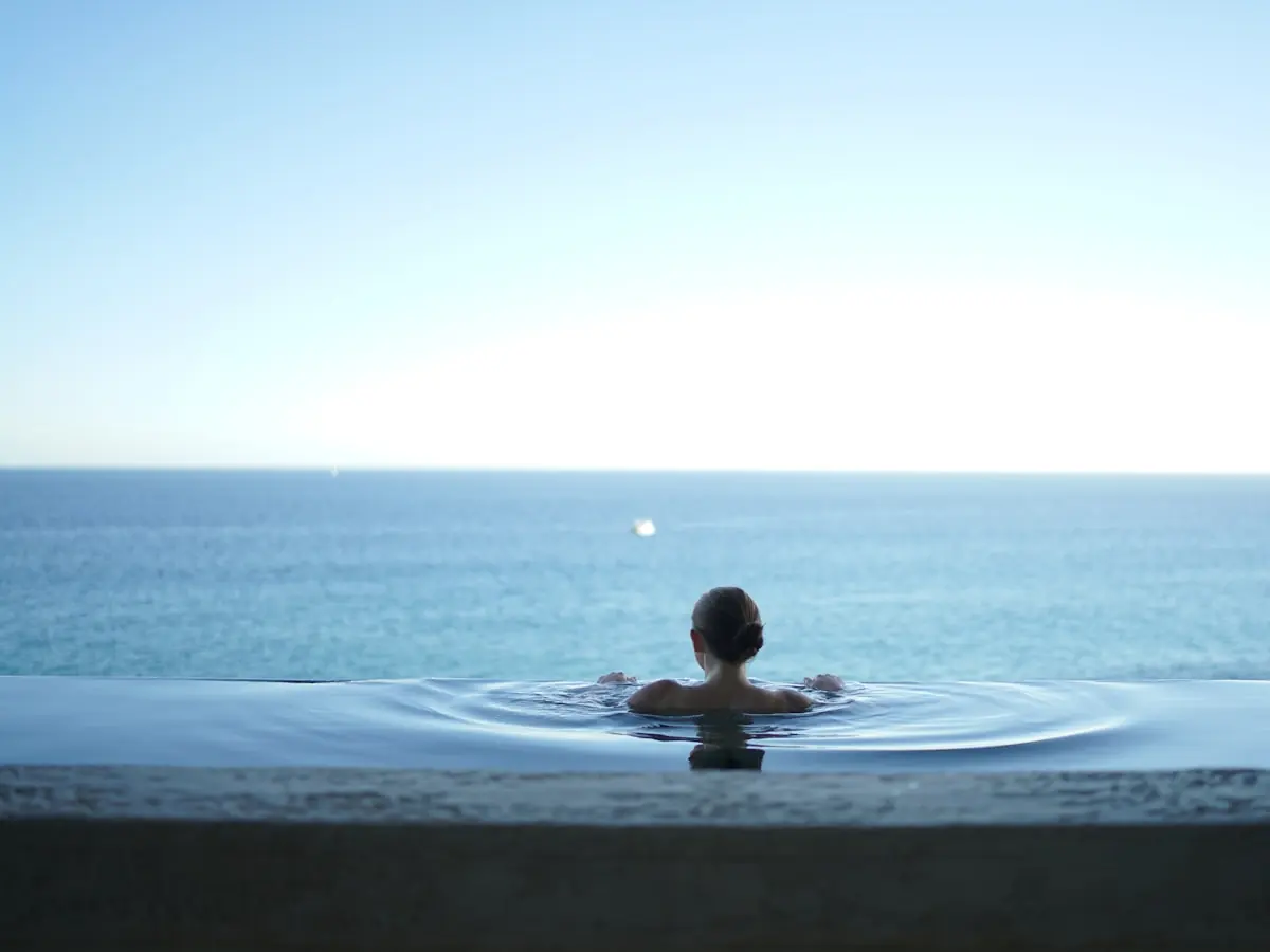 Person resting in calm water at the horizon